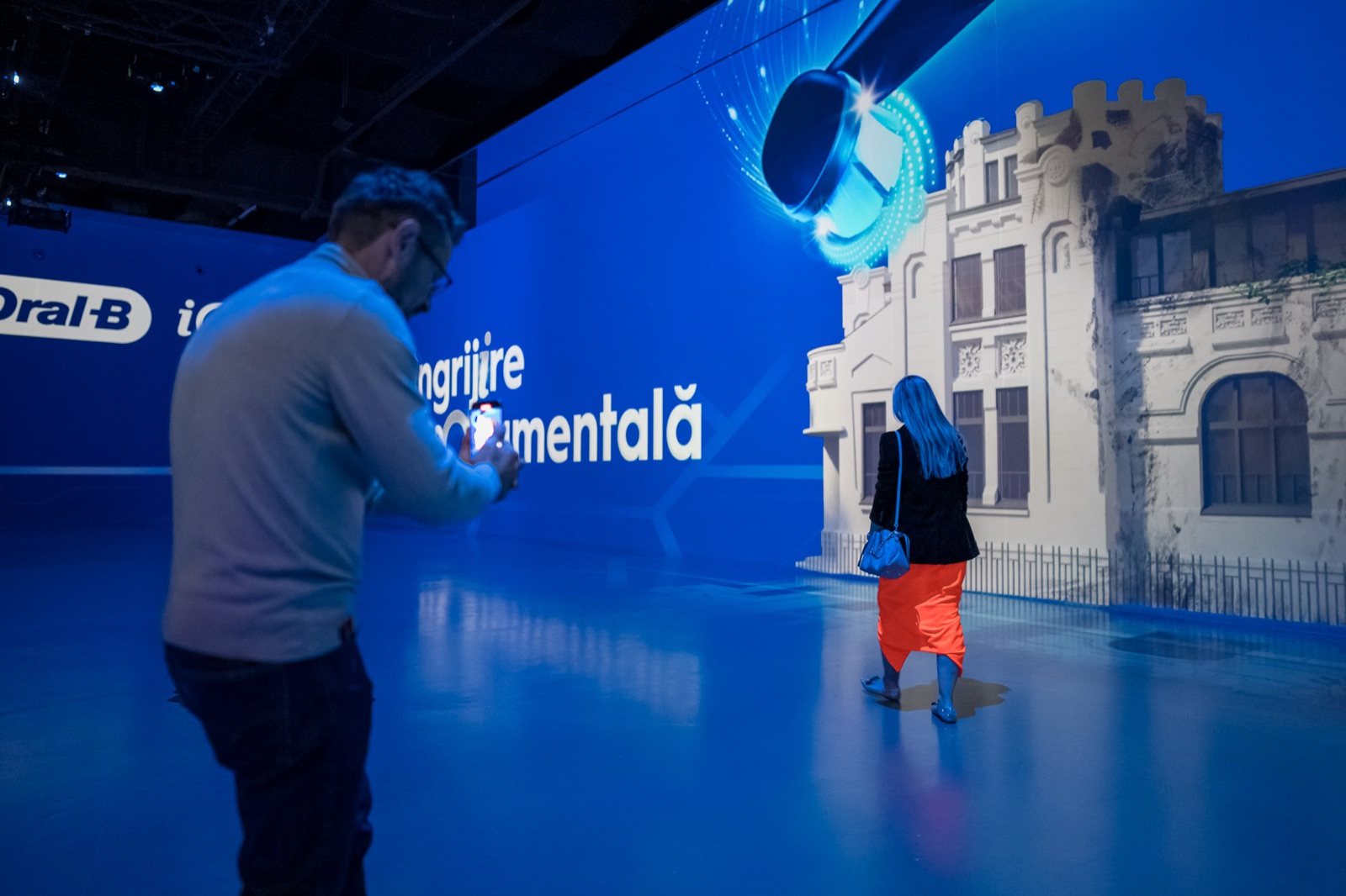 Guests film the projected restoration at MINA.