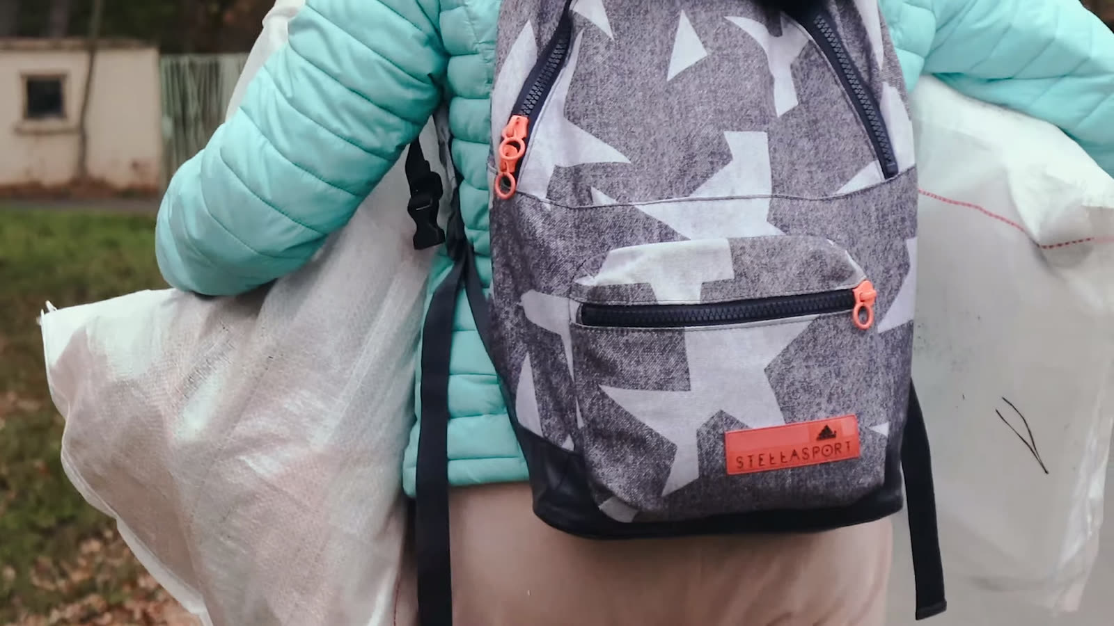 A school backpack, worn while hauling sacks of bottles.