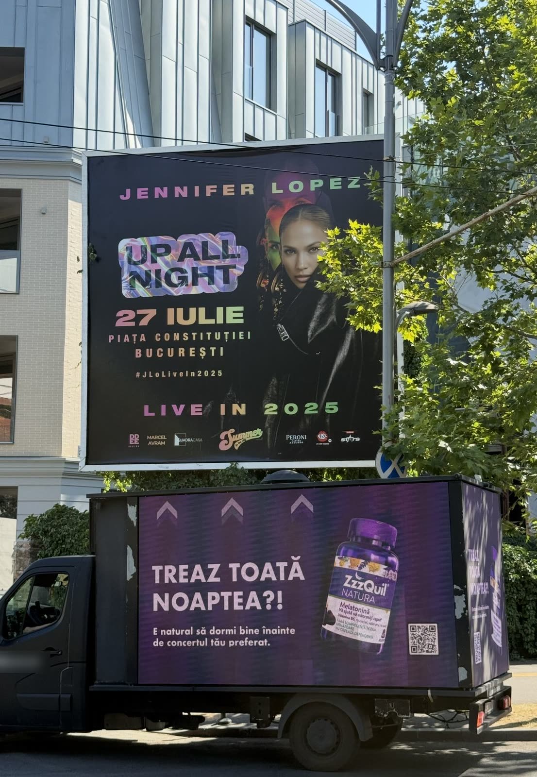 'TREAZ TOATĂ NOAPTEA?!' on the van, directly beneath the 'UP ALL NIGHT / 27 IULIE, Piața Constituției' poster.